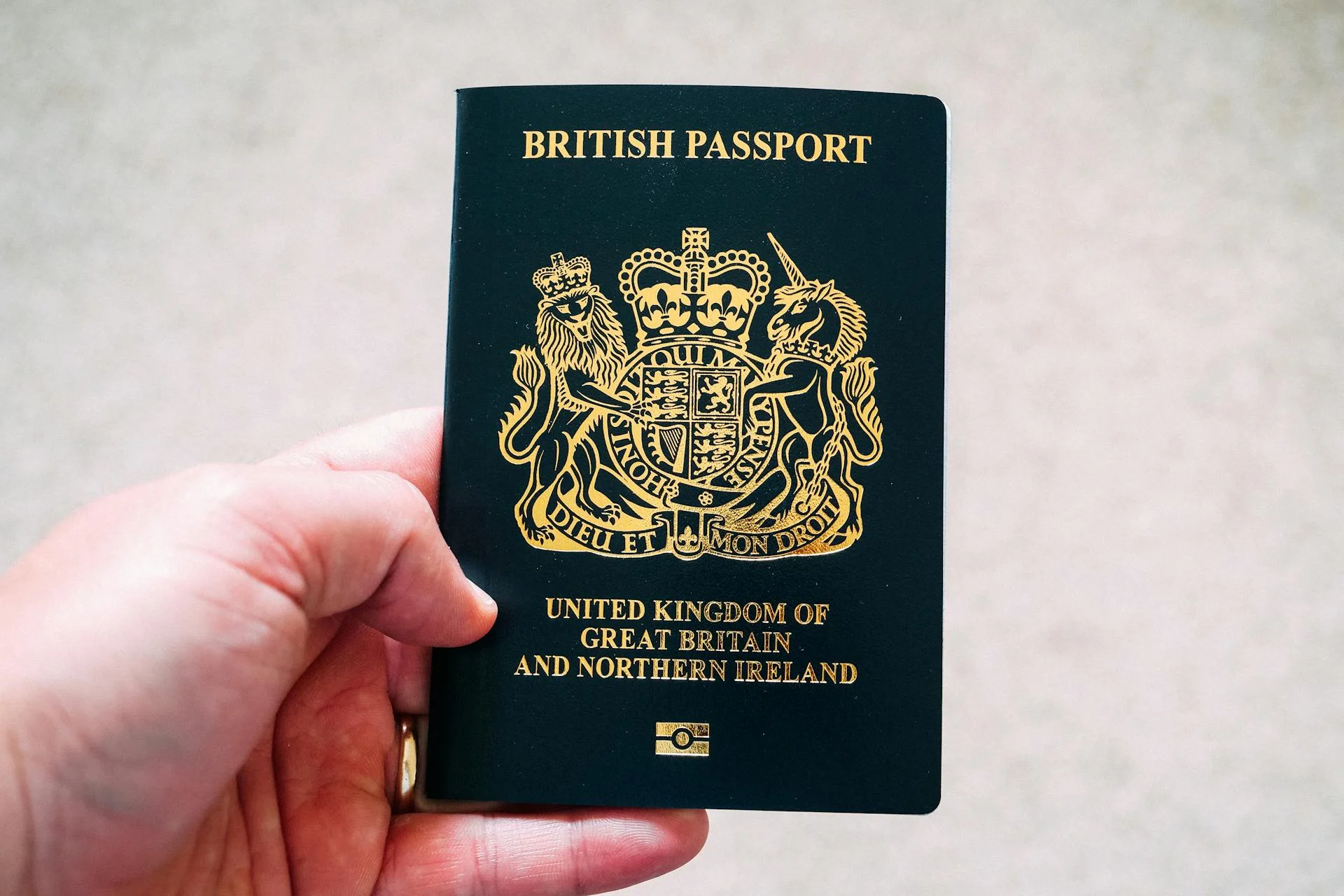 a hand holding british passport